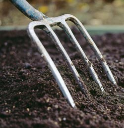 turn soil with pitchfork