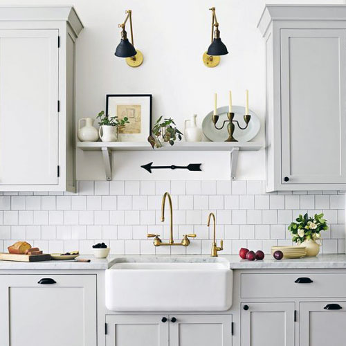 Ceramic tile is a beautiful, crisp, and clean option for the backsplash of your tiny house kitchen. Whether you choose all white like this kitchen or another color, it's an attractive choice.
