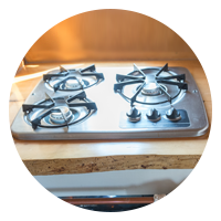 A three-burner gas stove is an excellent idea for a tiny house kitchen.