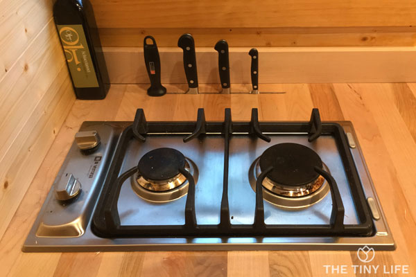 two burner propane stove in a small kitchen in a tiny house