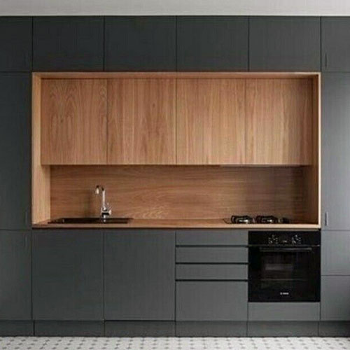 A wood backsplash is versatile and looks rustic or modern, like this slate grey tiny house kitchen with a teak backsplash.