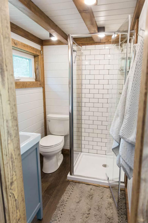 off grid tiny house bathroom with glass shower