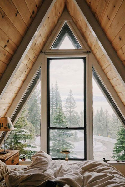This A-frame loft has plenty of windows to look out on the snowy landscape below.