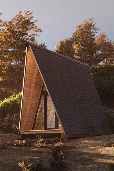 A highly-pitched roof on this A-frame tiny house adds to the space while covering the porch.