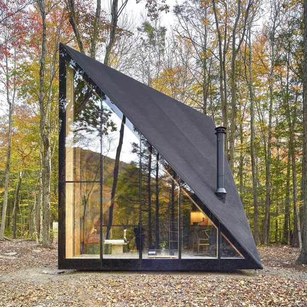 This architecturally beautiful A-frame house has a glass front and an alternative shape, making it a unique choice.