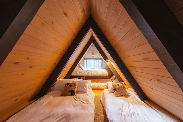  A loft space in this A-frame features plenty of room for several beds.