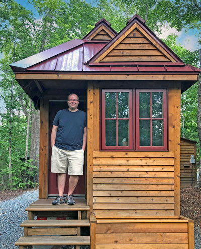 Ryan Mitchell in his tiny house living a simple life