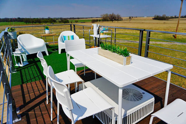 table and chairs on tiny house rooftop deck