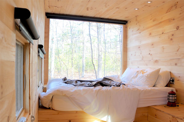 wall window in tiny house bedroom