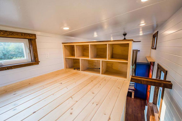storage walls in tiny house bedroom