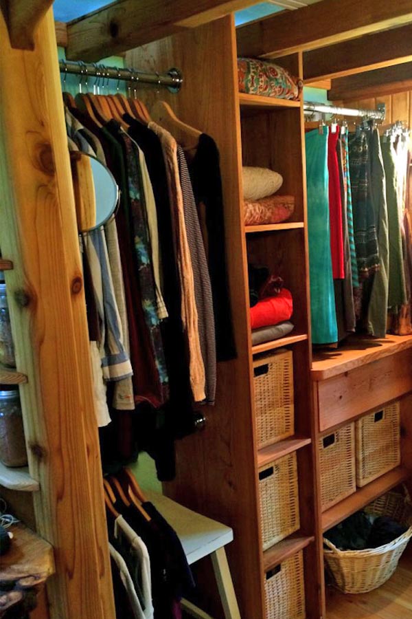 tiny house closet with baskets and hanging bar