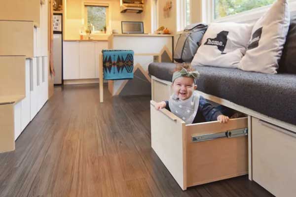 tiny house couch storage as mini crib
