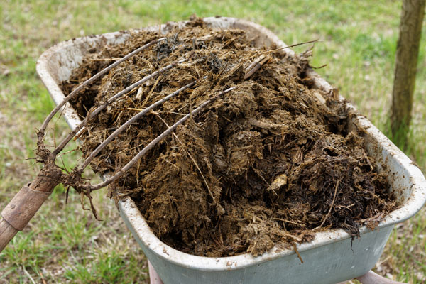 mixing compost pile