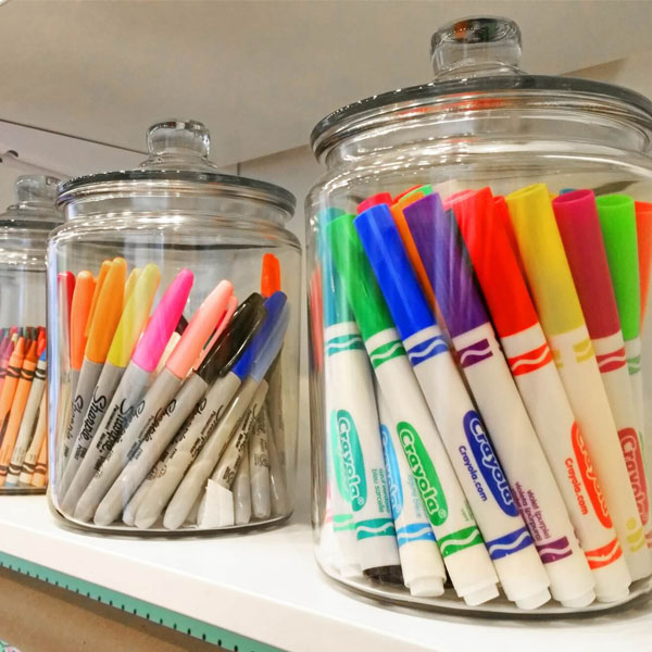 pens and markers organized in jars