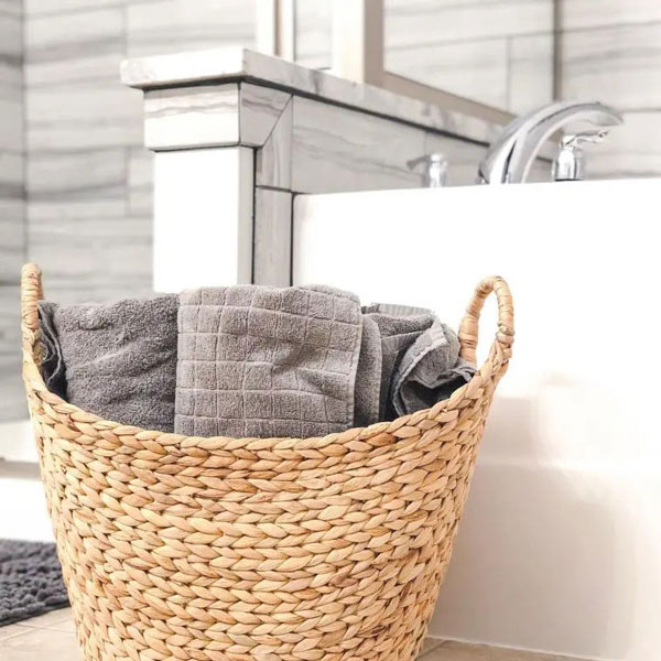 use a wicker basket for towel storage