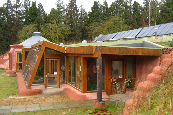 earthship home with glass and steel