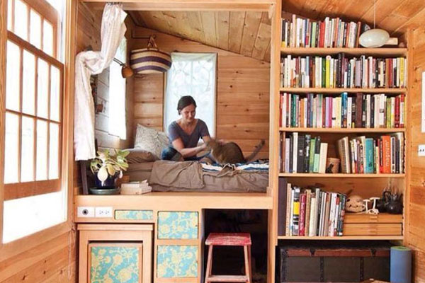 tiny house loft area with bookshelves