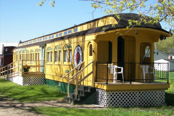 train car house exterior with porch